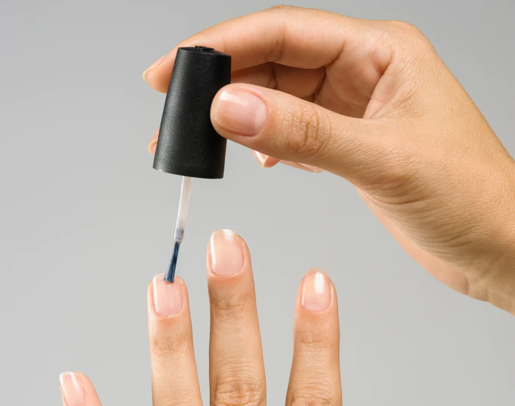 What distinguishes base coats from top coats in nail care
